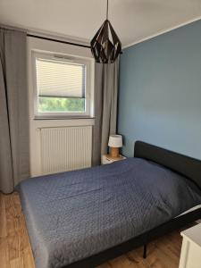 Ένα ή περισσότερα κρεβάτια σε δωμάτιο στο Apartament Igo