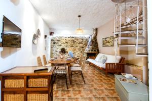 a living room with a table and chairs and a couch at Anna's Village House in Perivólia