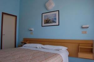 Postel nebo postele na pokoji v ubytování Hotel Vittoria