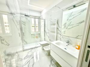a white bathroom with a sink and a toilet at Licheni R-home in Rome +24 photos