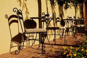 a row of chairs and tables in a patio at Los Arboles Hotel in Palm Springs