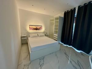 a small bedroom with two beds and a window at Licheni R-home in Rome