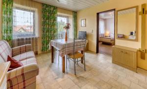 a living room with a table and a couch at Ferienhaus für Familien und Gruppen in Sankt Oswald