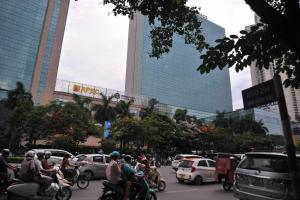 a group of people riding motorcycles on a busy city street at Đại Dương Xanh 502TDH204 in Hanoi