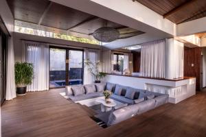 a living room with a couch and a table at Prana Cabin - Ezra Viniti Resort in Tagaytay