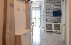 a hallway with a living room with a wall of reclaimed wood at Roberta in Rosignano Solvay +13 photos