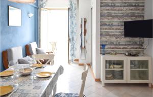 a dining room with a table and a tv at Roberta in Rosignano Solvay