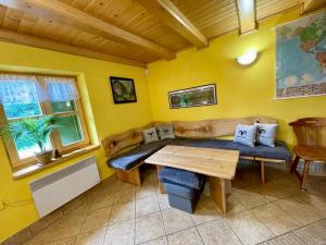 a living room with a couch and a table at Baranówka in Kamesznica