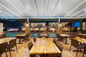 a dining room with wooden tables and chairs at Alados Otel in Turgut