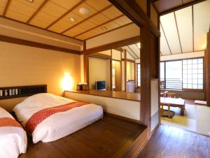 a bedroom with a bed in a room at Kira No Sato in Ito