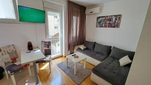 a living room with a couch and a table at Maya 's home - Vracar in Vračar (historical)