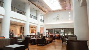 a restaurant with tables and chairs in a building at Krungsri River Hotel in Phra Nakhon Si Ayutthaya