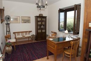 a room with a desk and chairs and a window at Casa Lippi in Casal Velino