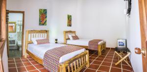 Postel nebo postele na pokoji v ubytování Hotel Brisas La Gaviota Mariquit-Tolima