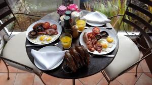 a table with two plates of breakfast food on it at Watchcombe House in Colyton
