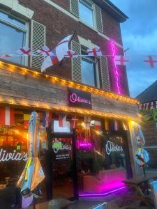 a restaurant with a neon sign in front of it at Skegness Town Centre Apartment 2 in Skegness