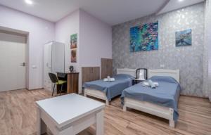 a hospital room with two beds and a table at Art-Gallery Avlabari in Tbilisi City