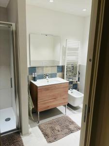 a bathroom with a sink and a mirror and a tub at La Mombellina OLTRE HOME HOLIDAYS in Sanremo +6 photos