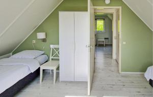 een slaapkamer met groene muren en een witte kast bij Gorgeous Home In Woudsend With Wifi in Woudsend +12 foto's