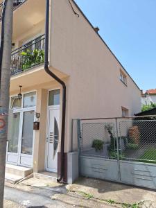 a building with a door and a fence in front of it at Studio D&I in Vranje +32 photos