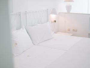 Postel nebo postele na pokoji v ubytování Hostal del Cabo