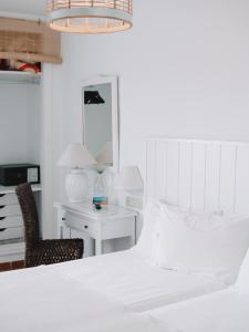 Postel nebo postele na pokoji v ubytování Hostal del Cabo