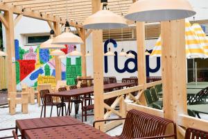 un restaurante con mesas y sillas de madera y un mural en FIAP Paris, en París