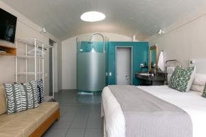 a bedroom with a large bed and a sink at Speelhuis Studios in Langebaan +13 photos