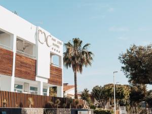 a building with a palm tree in front of it at Hotel MC San José in San José