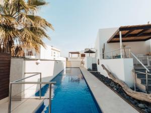 a swimming pool in the middle of a house at Hotel MC San José in San José