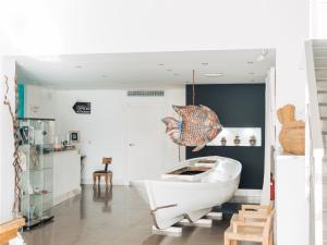 a bathroom with a tub and a boat in it at Hotel MC San José in San José