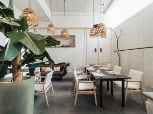 a dining room with a table and chairs and a couch at Hotel MC San José in San José