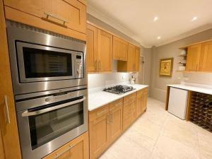 a kitchen with wooden cabinets and a stainless steel appliance at No1 Chapel Street in Grassington