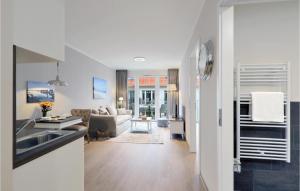 a kitchen and living room with a couch and a sink at Baltischer Hof Apartment 39 in Boltenhagen