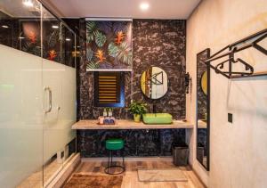 a bathroom with a green sink and a shower at Attic Hotel in George Town