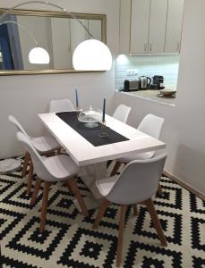a dining room with a white table and chairs at Hello Downtown Apartment - Eiffel in Budapest