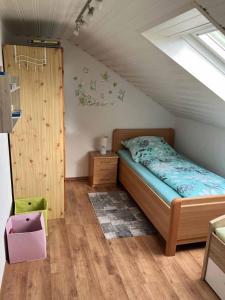 a bedroom with a bed in a attic at Ferienwohnung Haus Elfriede in Neukirchen beim Heiligen Blut +37 photos
