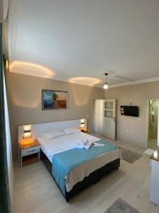 a bedroom with a large bed and a television at TULİPA SUİTEs TRABZON in Bostancı +55 photos