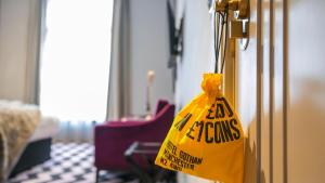a yellow bag is hanging on a door at Hotel Gotham in Manchester