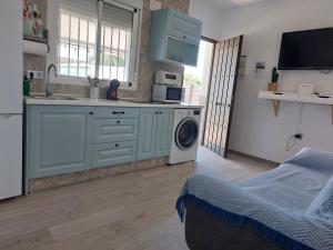 a kitchen with a sink and a washing machine at La casita de Valeria in El Palmar