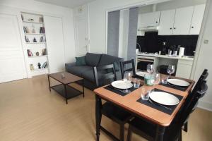 a living room with a table and a couch at Escapade vue mer in Dunkerque