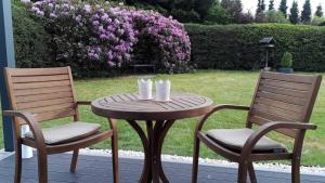 two chairs and a table and a table and chairs at Ferienhaus in Kirburg mit Großer Terrasse in Kirburg
