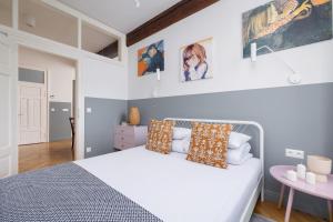 a bedroom with a white bed and a table at 2 bedroom apartment Św Jana - Main Square in Kraków