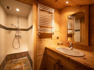 a bathroom with a sink and a mirror at Chalet 4**** cosy, village, garage, WIFI - FR-1-304-21 in La Clusaz +15 photos
