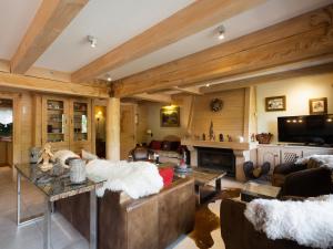 a living room with a couch and a fireplace at Chalet 4**** cosy, village, garage, WIFI - FR-1-304-21 in La Clusaz