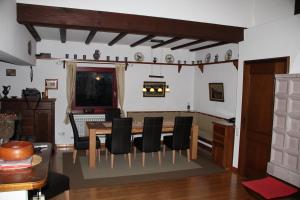 a dining room with a table and black chairs at Ferienhaus Schanze19 in Schmallenberg