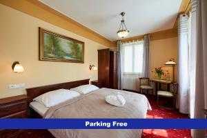 a hotel room with a bed and a desk at Hotel Stará Pekárna s privátním wellness in Liberec