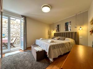 a bedroom with a bed and a large window at Apartmani Barica in Novigrad Istria
