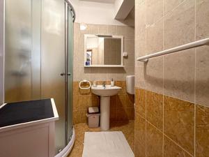 a small bathroom with a sink and a shower at Apartmani Barica in Novigrad Istria +28 photos