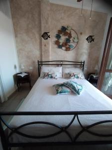 Postel nebo postele na pokoji v ubytování Casa Claudia Villasimius